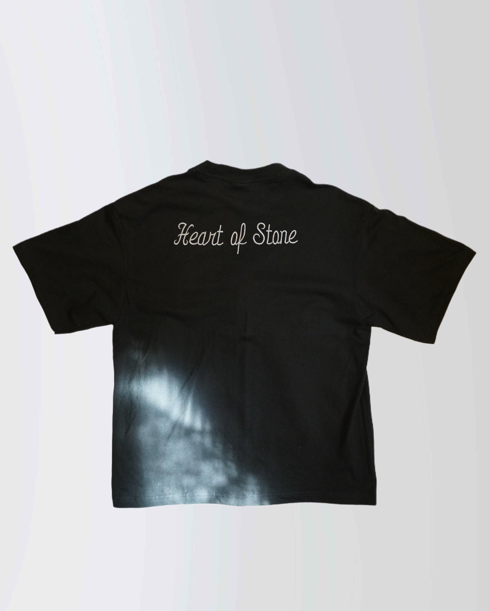 Black t-shirt with 'Heart of Stone' text on a white background
